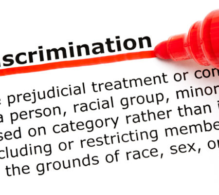 Definition of the word Discrimination underlined with red marker on white paper.
